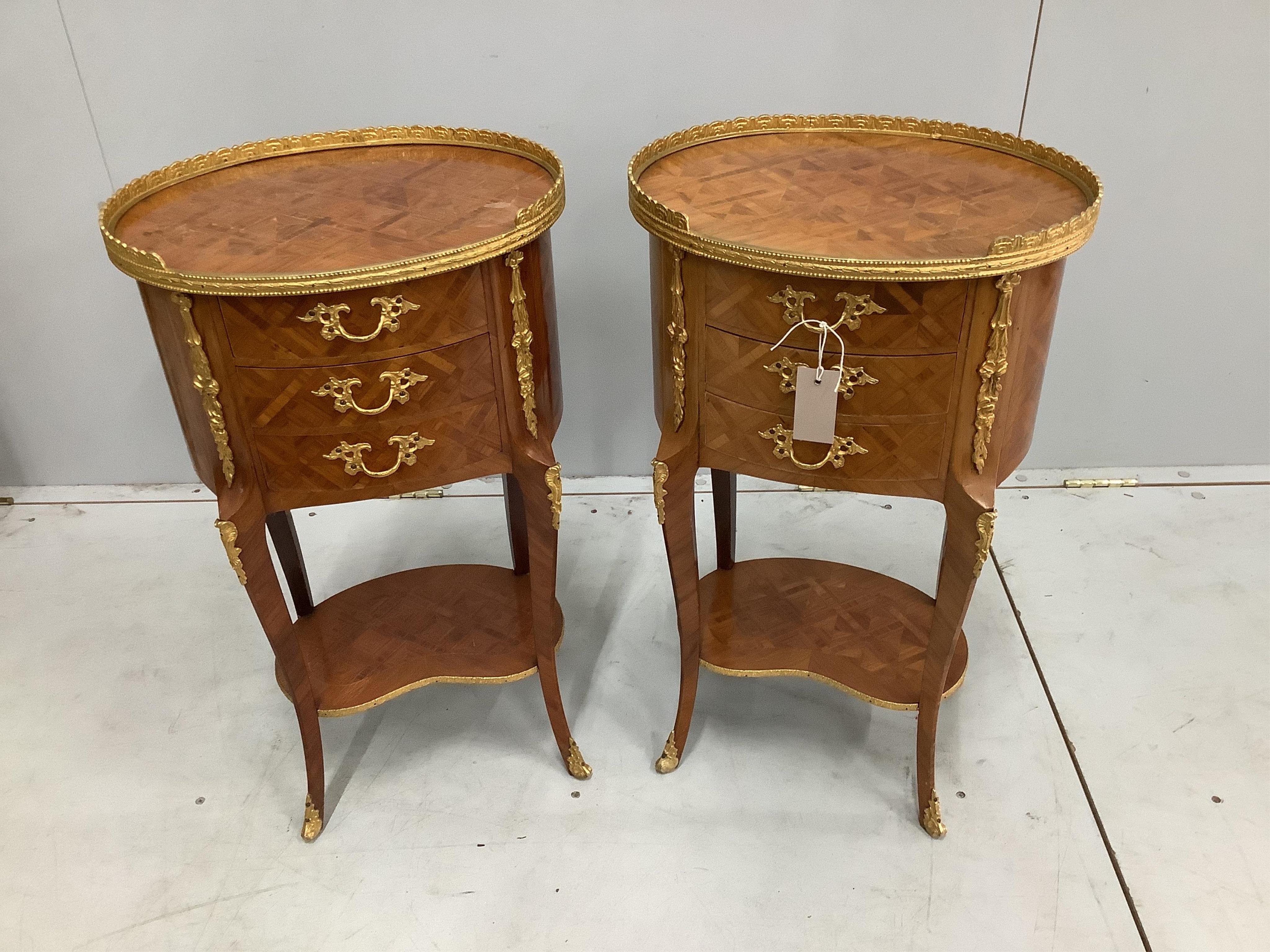 A pair of French transitional style gilt metal mounted kingwood oval three drawer bedside chests, width 40cm, depth 30cm, height 69cm